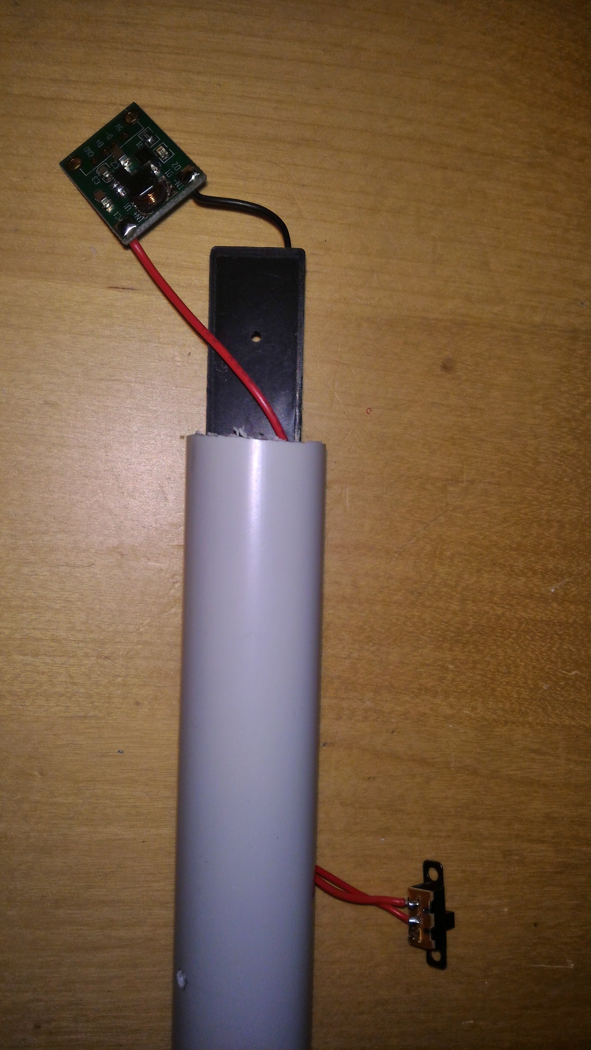 Boost converter, switch and battery holder fitted in the end section